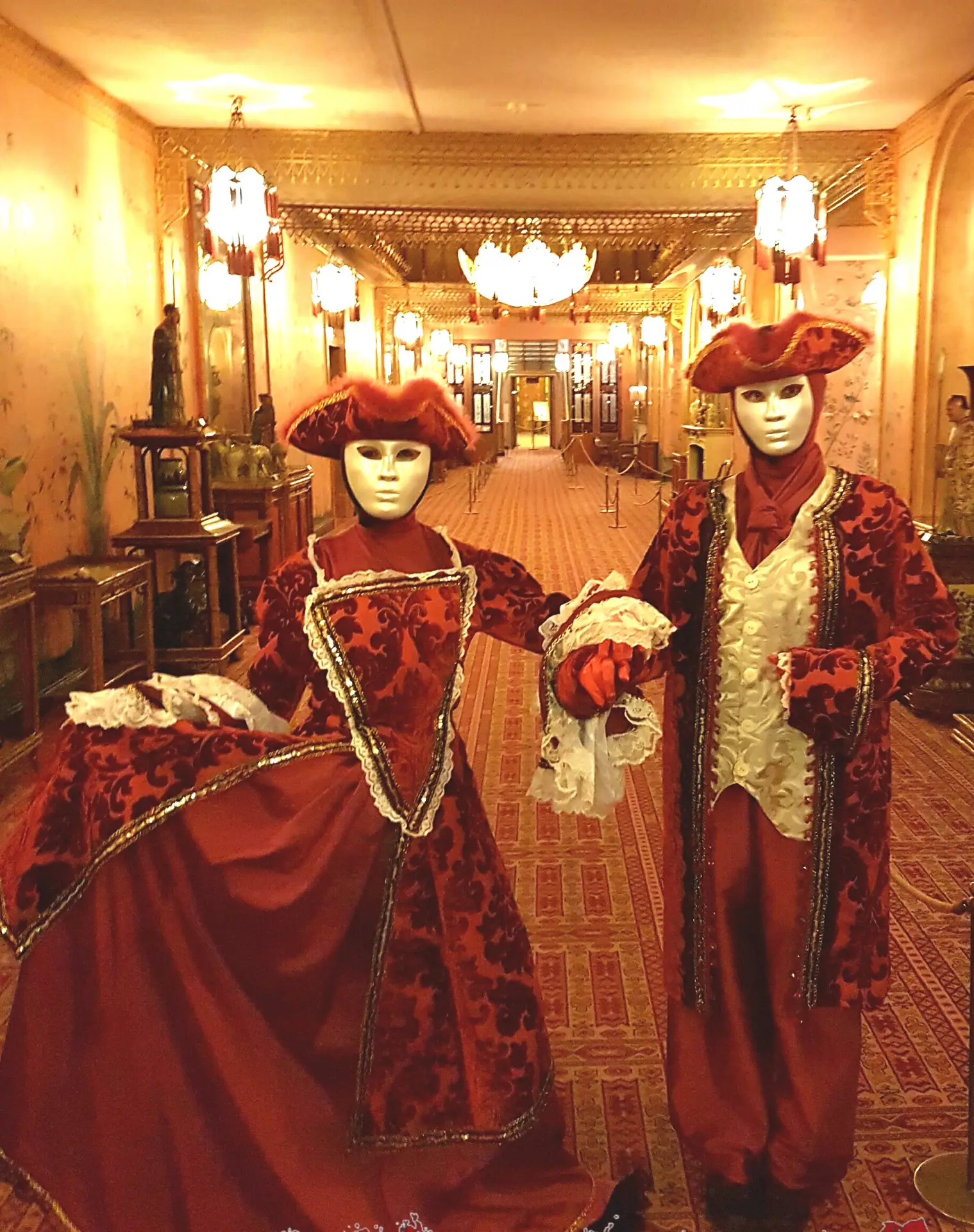 masquerade actors in opulent costumes