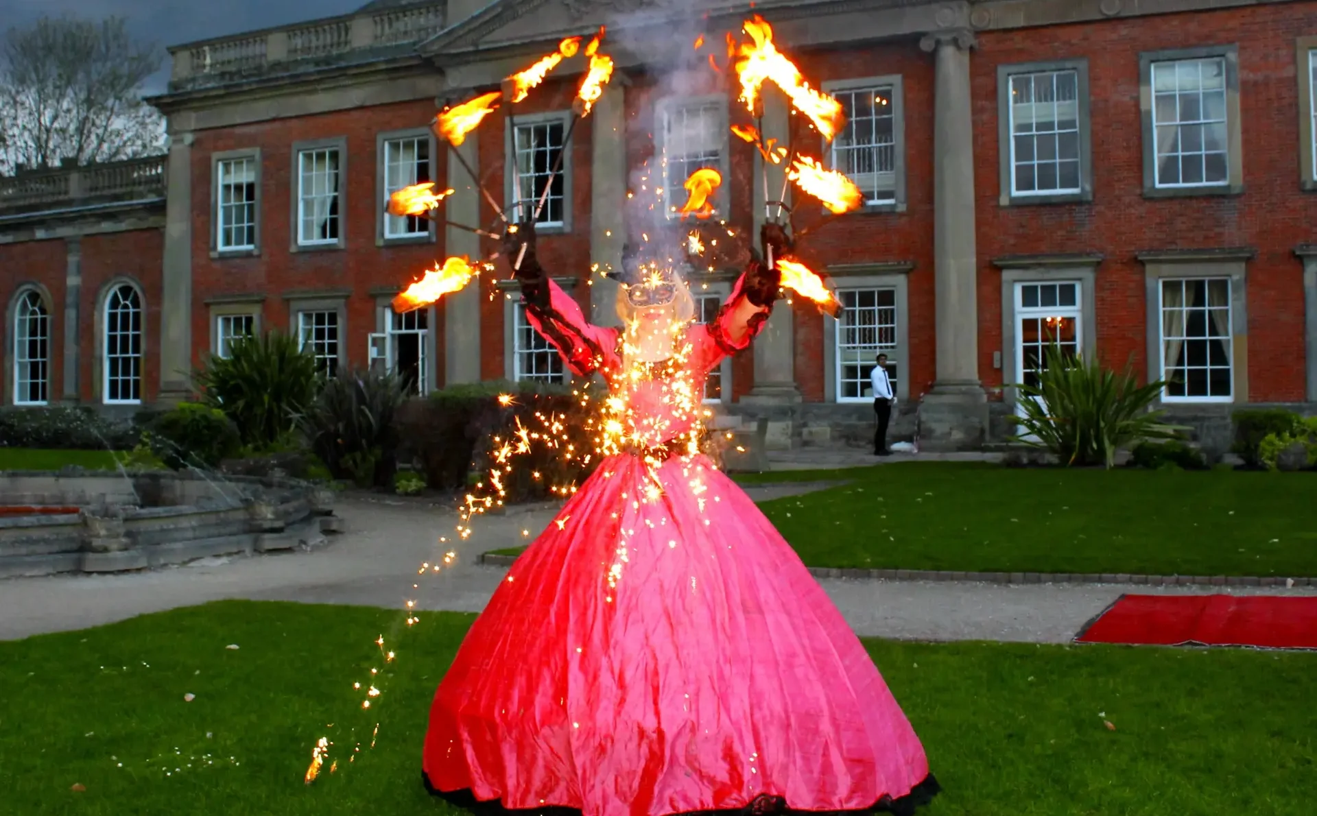 masquerade fire performer outside a country house venue