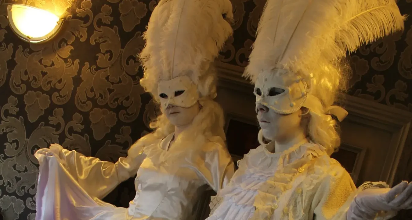 masquerade human statue actors dressed in white