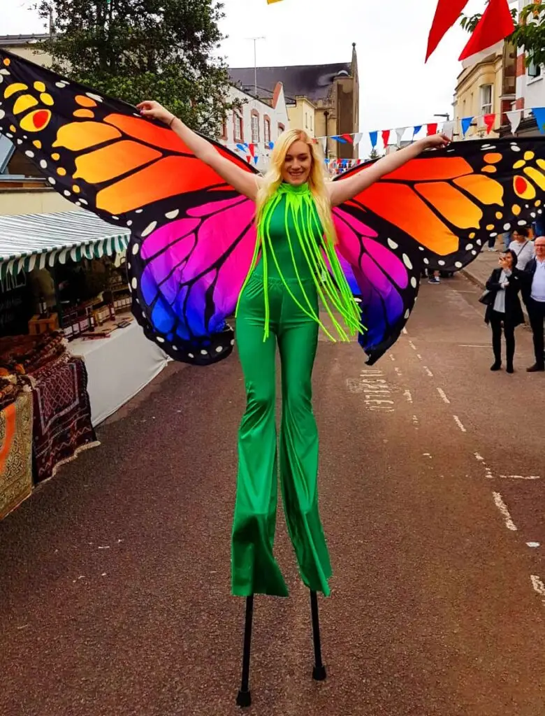 butterfly stilt walker in a UK street
