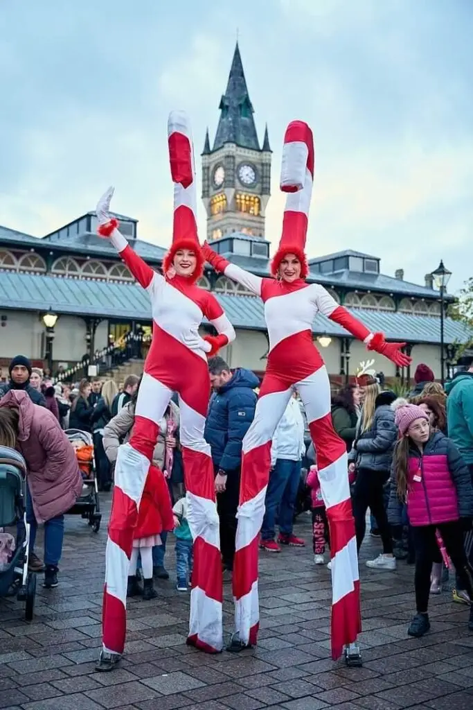 hire candy cane stilt walkers for a christmas light switch on