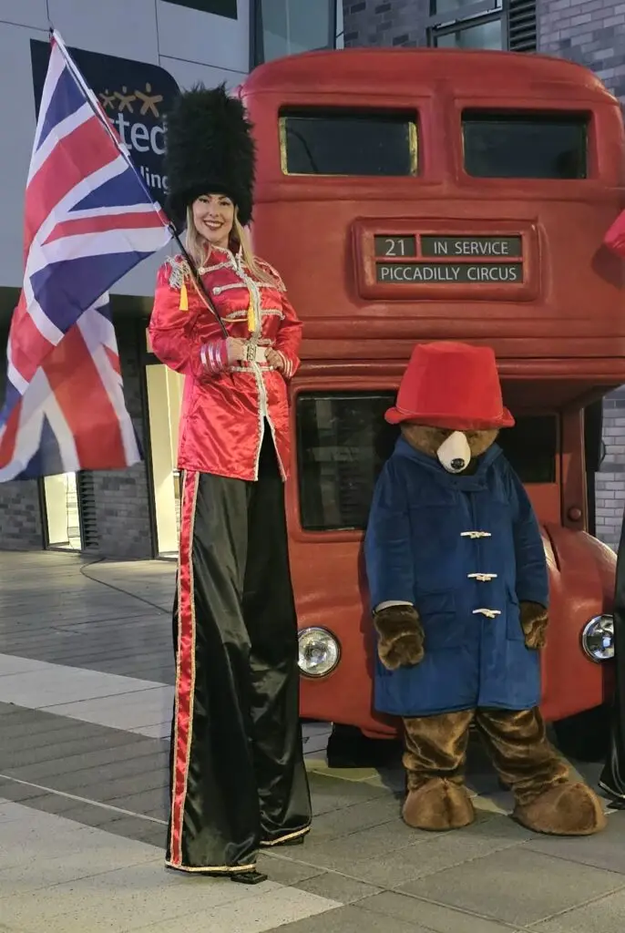royal guard stilt walker and paddington bear