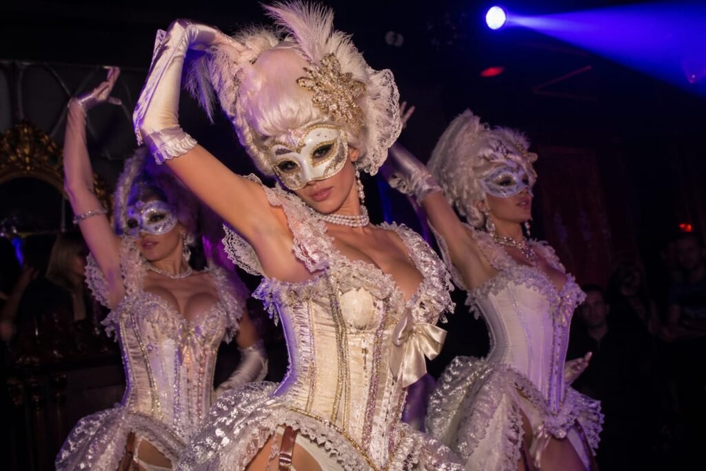 3 masquerade dancers at an event