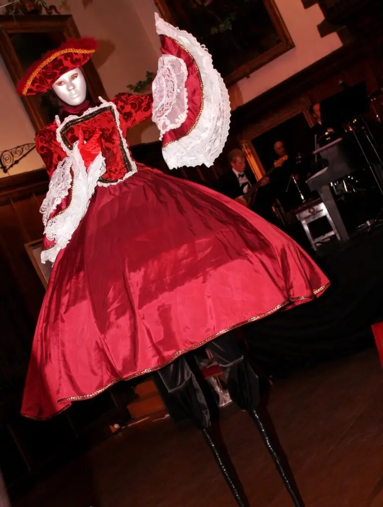 masquerade stilt walker in a red dress
