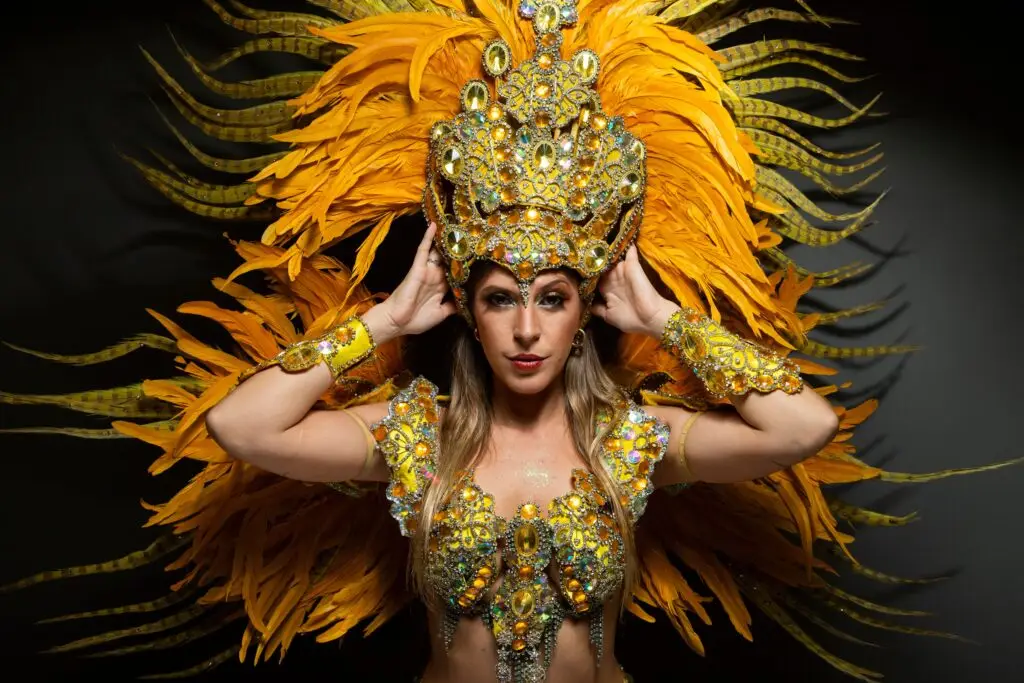 Detailed portrait of a woman in a colorful carnival costume with extravagant feathers and jewels.