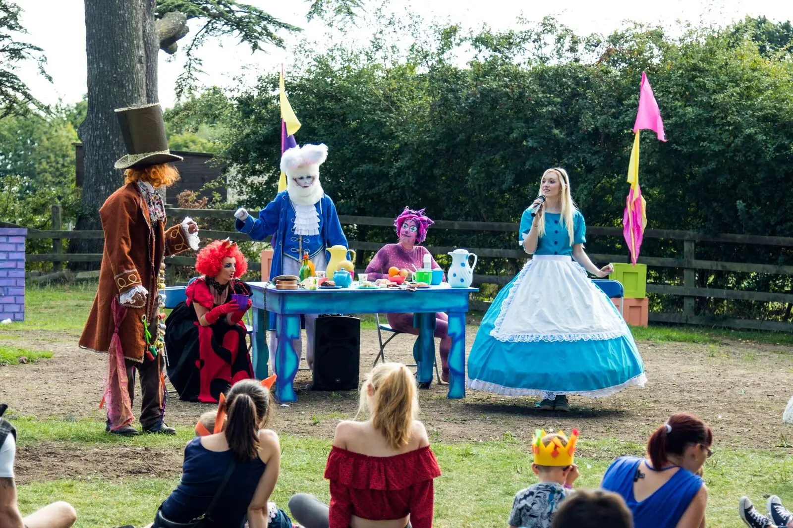 actors performing a mad hatters tea party show