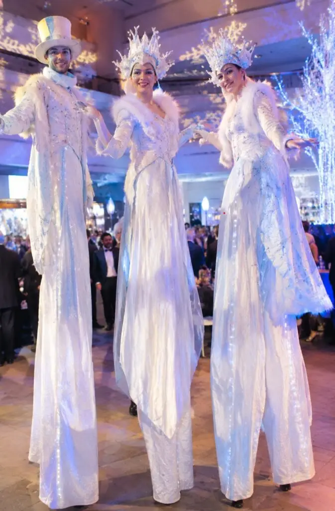 three winter wonderland stilt walkers at a corporate event